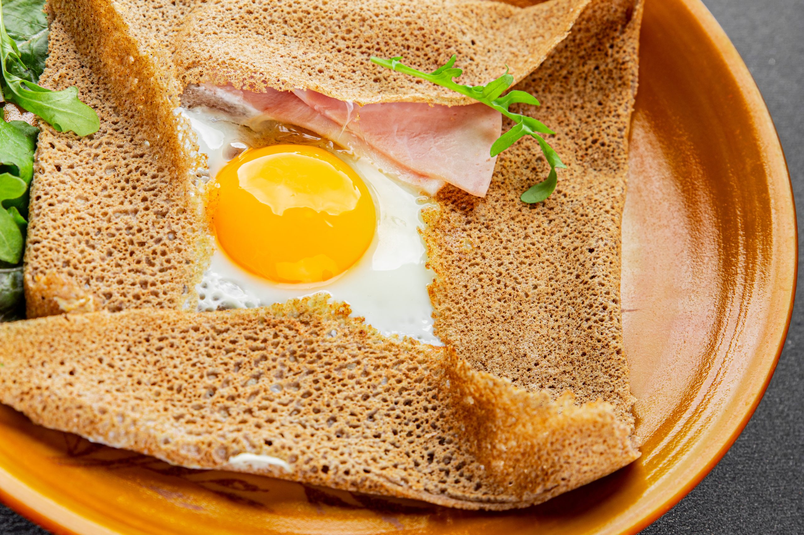 Galette sarrasin fried egg in crepe Breton galette galette complete fresh delicious gourmet food background on the table rustic food top view copy space