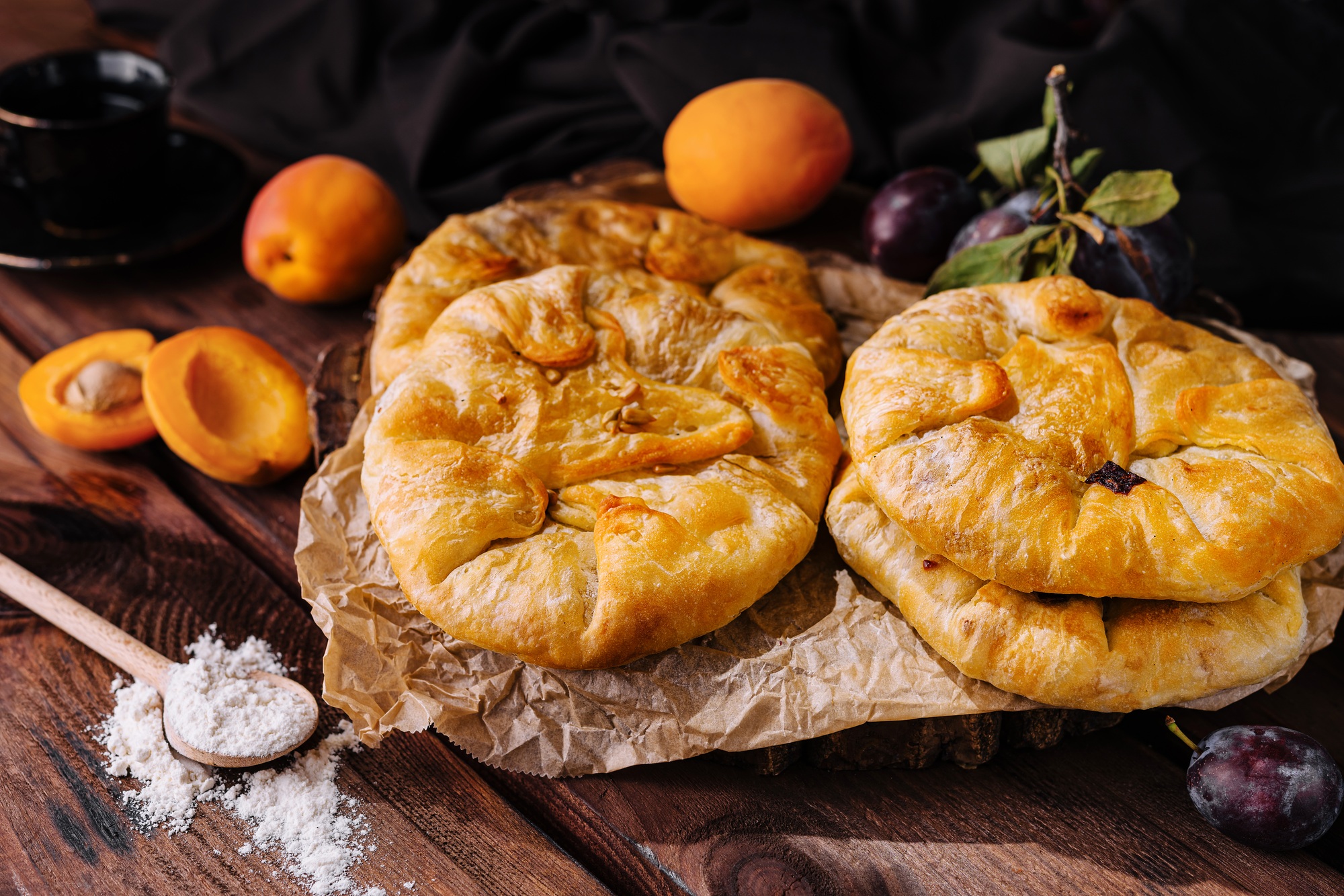 Rustic homemade fruit galettes on wooden table