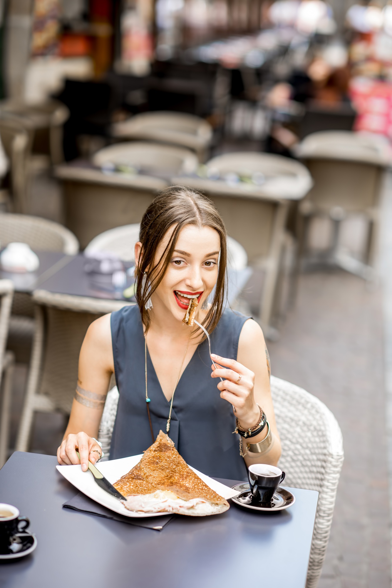 Woman eating galette meal at the restaurant in France